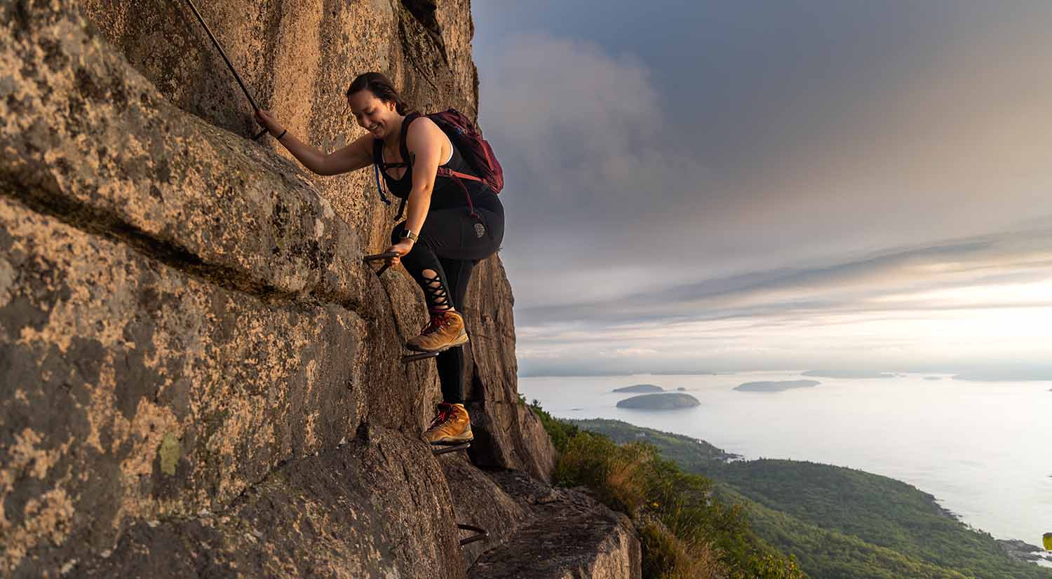 An Acadia National Park Intern climbs up the Precipice Trail going up Champlain Mountain during off time in Acadia National Park. (Photo by Sam Mallon/Friends of Acadia)